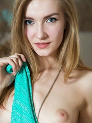 A stunning statuesque beauty Maryana is wearing turquoise lace panties and a flowy blouse